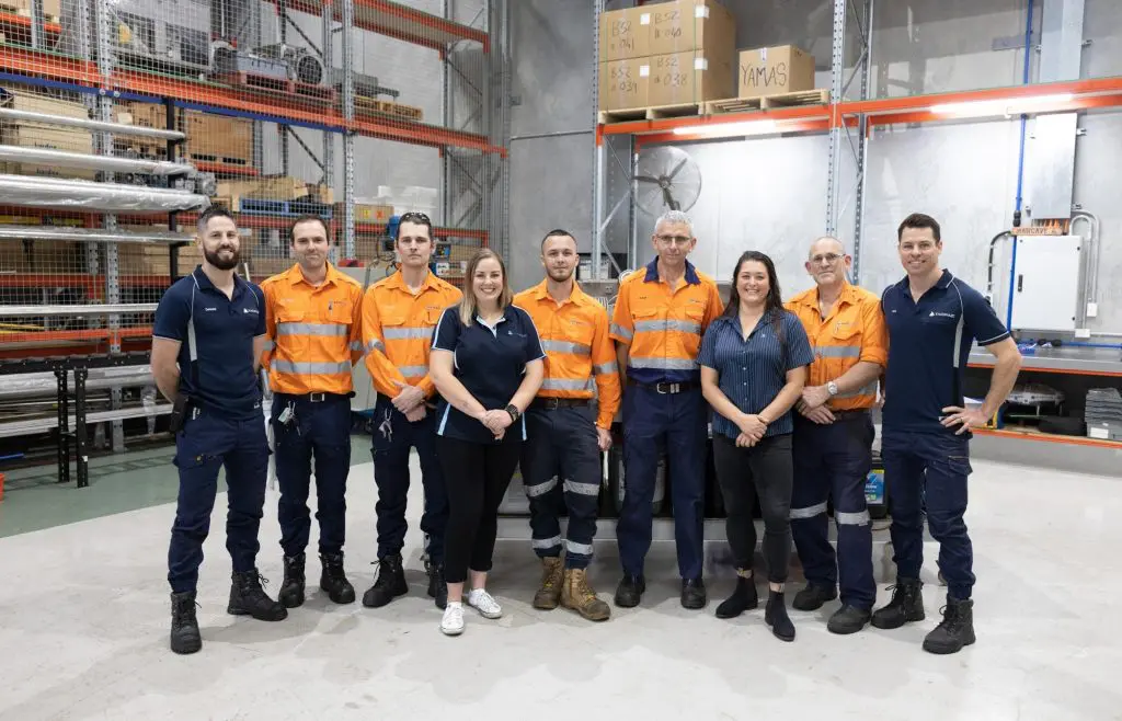 The team at VACPAC Australia posing for a picture in their warehouse.