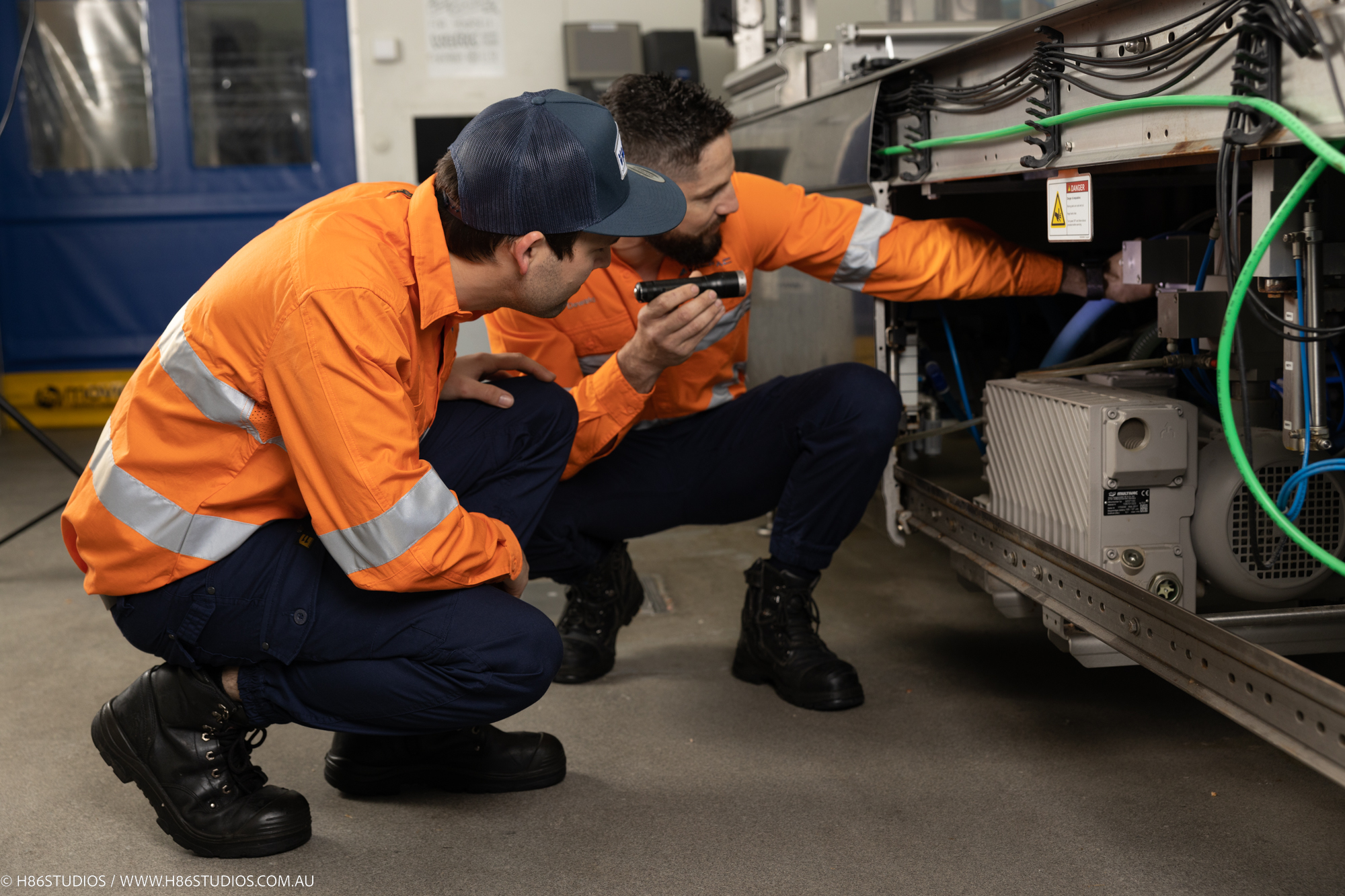 VACPAC technicians inspecting a vacuum packaging machine for any servicing needs.